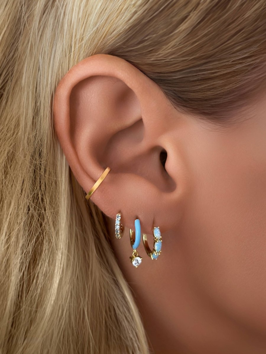 Blue CZ Sapphire Huggie Earrings by Emily Volaski