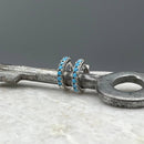 Turquoise CZ Huggie Hoops: Sterling Silver by Something Silver
