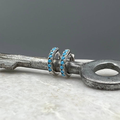 Turquoise CZ Huggie Hoops: Sterling Silver by Something Silver
